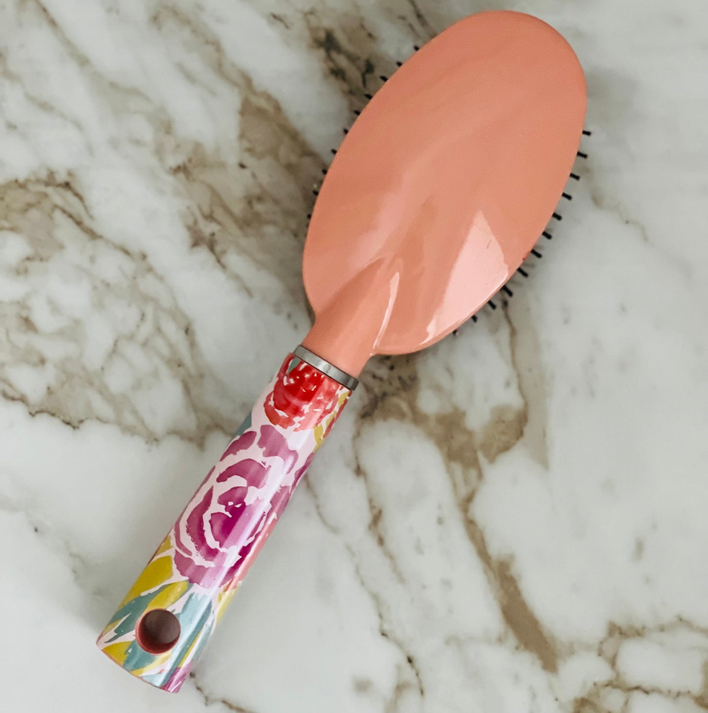 What's more beautiful than a floral brush? How about one that's personalized with your name! When you're searching for the perfect hairbrush, look no further than this custom personalized hair brush. This oval hairbrush is crafted with the highest quality materials and designed to last. We know you'll love using it every day - it feels amazing on your hair and leaves it looking voluminous and luxurious. Plus, with its chic floral design, it is also chic. Peach