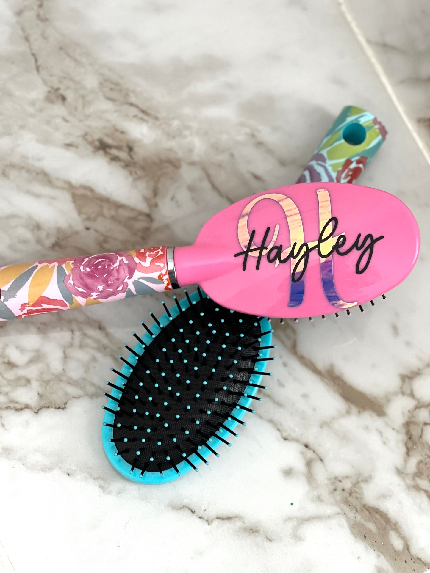 What's more beautiful than a floral brush? How about one that's personalized with your name! When you're searching for the perfect hairbrush, look no further than this custom personalized hair brush. This oval hairbrush is crafted with the highest quality materials and designed to last. We know you'll love using it every day - it feels amazing on your hair and leaves it looking voluminous and luxurious. Plus, with its chic floral design, it is also chic.