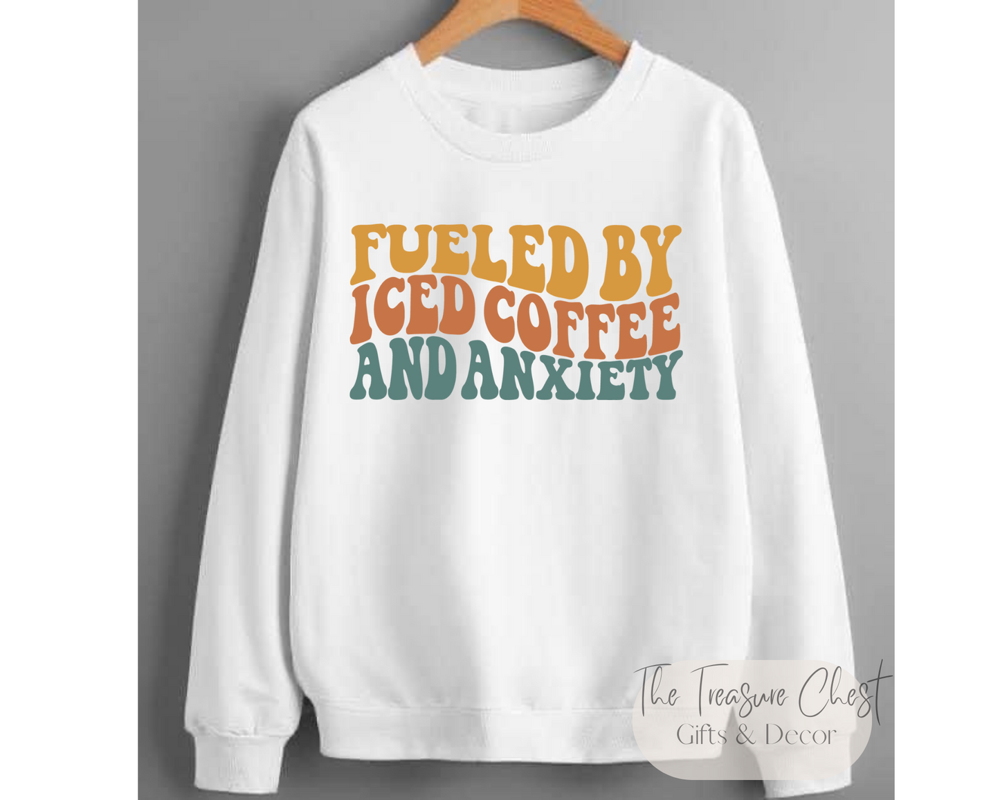 This Fueled By Iced Coffee and Anxiety Crewneck Sweatshirt is the perfect blend of comfort, style and humour. It features a design on the front that reads "fueled by iced coffee & anxiety" in bold neutral coloured lettering. The warped lettering adds some much appreciated dimension to this humorous sweatshirt. 