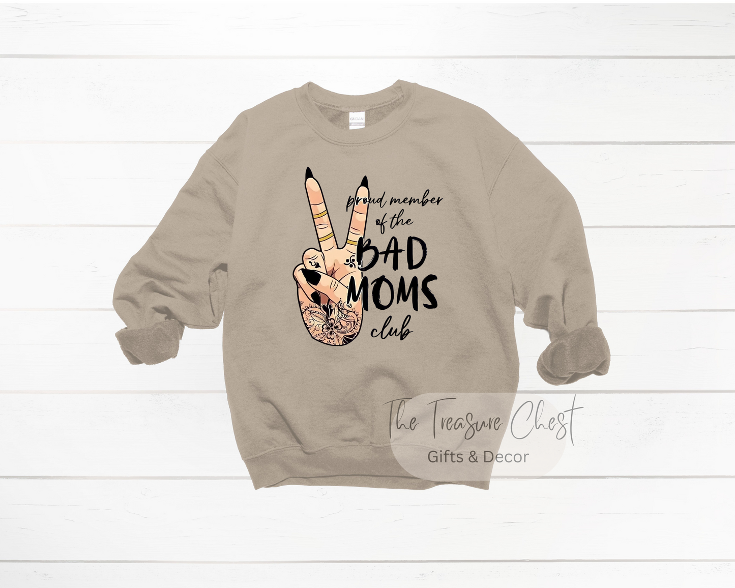 Whether you're a proud member of the Bad Mom's Club or just someone looking for a funny graphic sweatshirt to add to your wardrobe, look no further than our Bad Mom's Club crewneck sweatshirt. Featuring a hand peace sign graphic and quote.  Our sweatshirts are made of a heavy, yet soft and breathable material that maintains it's shape and size. Pair it with your favourite jeans or joggers for a casual look. Sand in colour