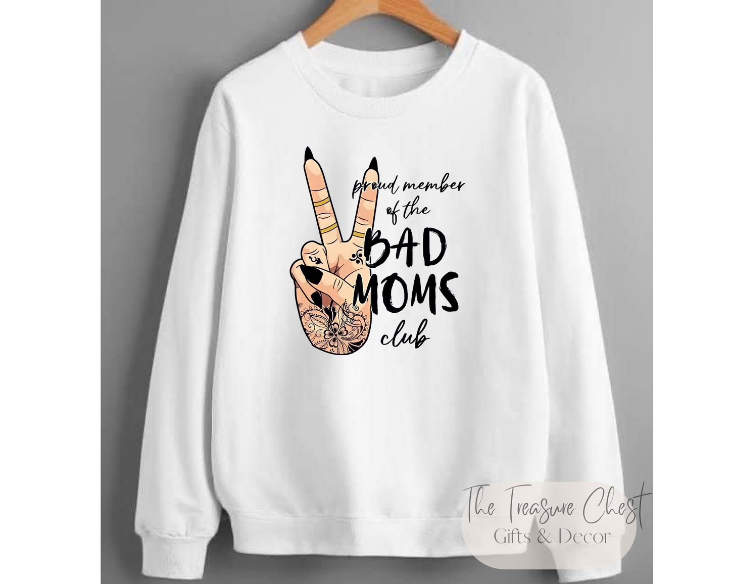 Whether you're a proud member of the Bad Mom's Club or just someone looking for a funny graphic sweatshirt to add to your wardrobe, look no further than our Bad Mom's Club crewneck sweatshirt. Featuring a hand peace sign graphic and quote.  Our sweatshirts are made of a heavy, yet soft and breathable material that maintains it's shape and size. Pair it with your favourite jeans or joggers for a casual look.White in colour