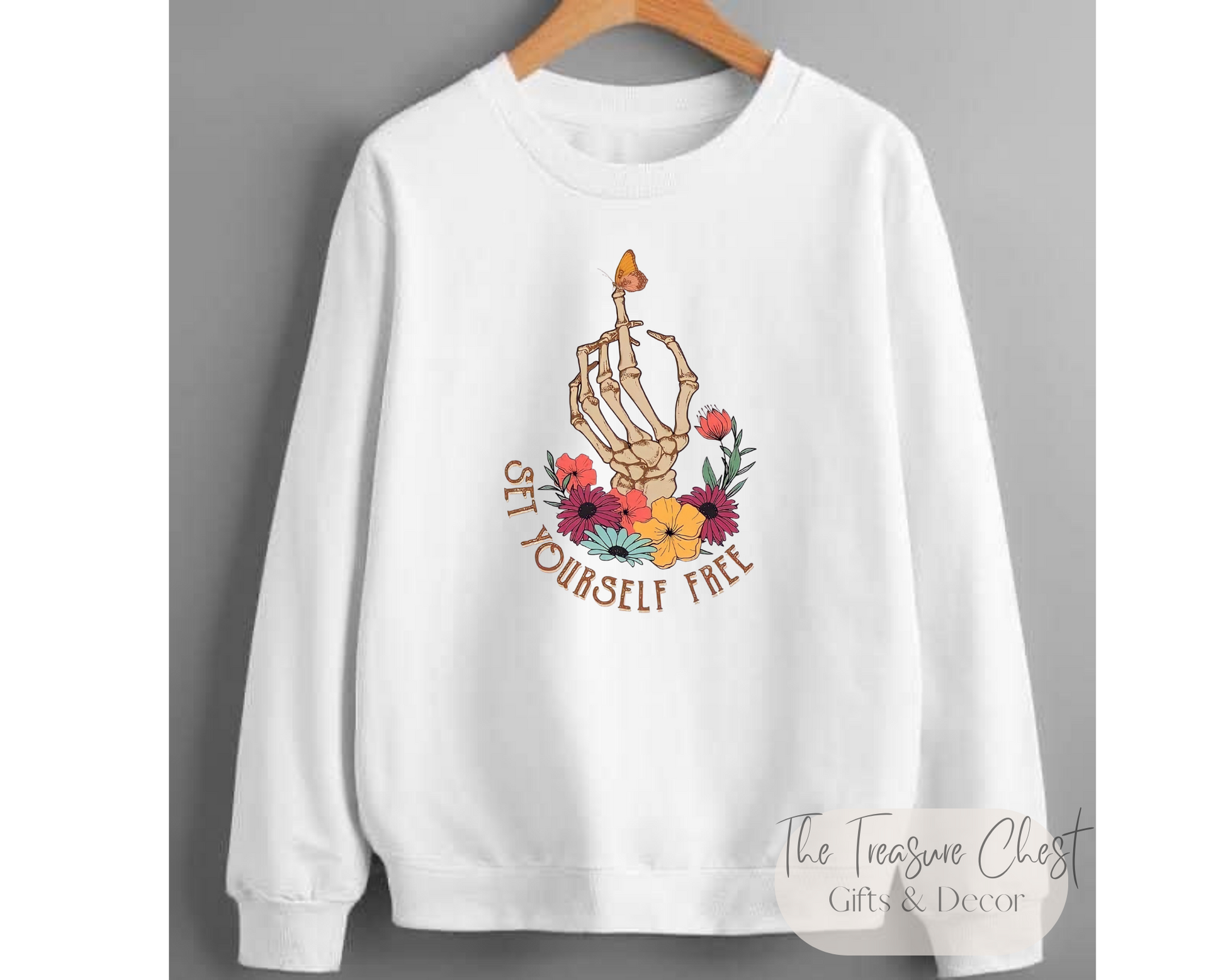 Our Set Yourself Free Graphic Crewneck Sweater features a skeleton hand with floral design on a crisp white sweatshirt. We have something for every woman and girl in your life. Our shirts are perfect for casual wear, workouts and yoga, as well as lounge around in style. Stay warm and cozy in soft premium material.  Our sweatshirts are made of a heavy, yet soft and breathable material that maintains it's shape and size. Pair it with your favourite jeans or joggers for a casual look.